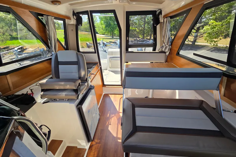 Slide: The Image of 2026 Cutwater C-248 Coupe interior with modern seating and panoramic windows. - 16