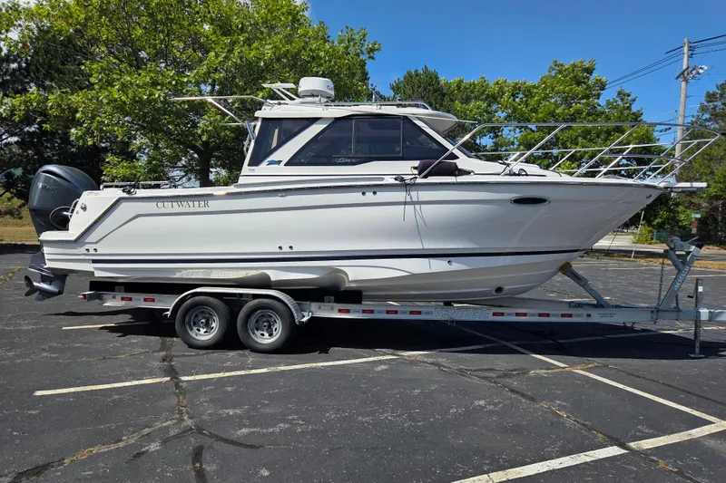 Slide: The Image of 2026 Cutwater C-248 Coupe boat on trailer in parking lot, sunny day. - 2
