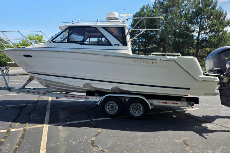 Slide: The Image of 2026 Cutwater C-248 Coupe boat on trailer in parking lot, side view. - 6