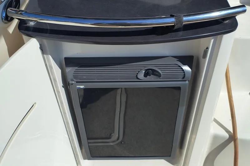 Slide: The Image of 2005 Sea Ray 270 SLX boat interior with compact refrigerator and sleek countertop. - 10