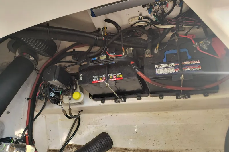 Slide: The Image of Engine compartment of a 2005 Sea Ray 270 SLX with visible batteries and wiring. - 13