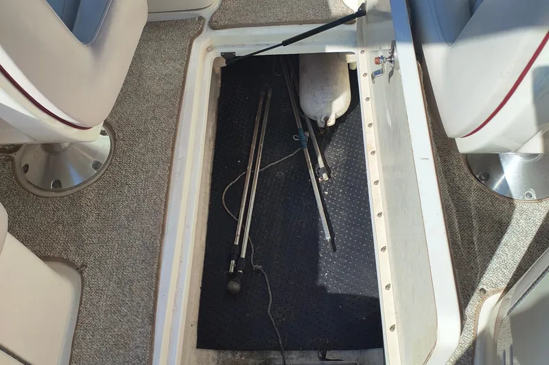 Slide: The Image of Open storage compartment in 2005 Sea Ray 270 SLX boat, showing interior details. - 14