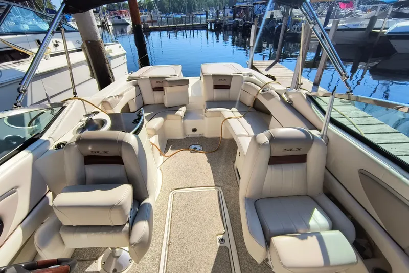 Slide: The Image of 2005 Sea Ray 270 SLX boat interior with luxurious seating at a marina. - 3