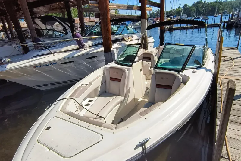 Slide: The Image of 2005 Sea Ray 270 SLX boat docked at marina, featuring spacious seating and sleek design. - 5