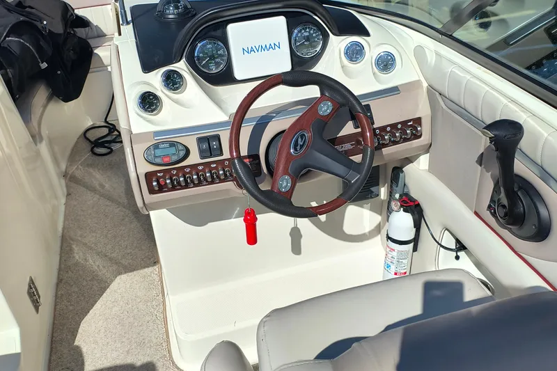 Slide: The Image of 2005 Sea Ray 270 SLX boat dashboard with steering wheel and navigation instruments. - 6