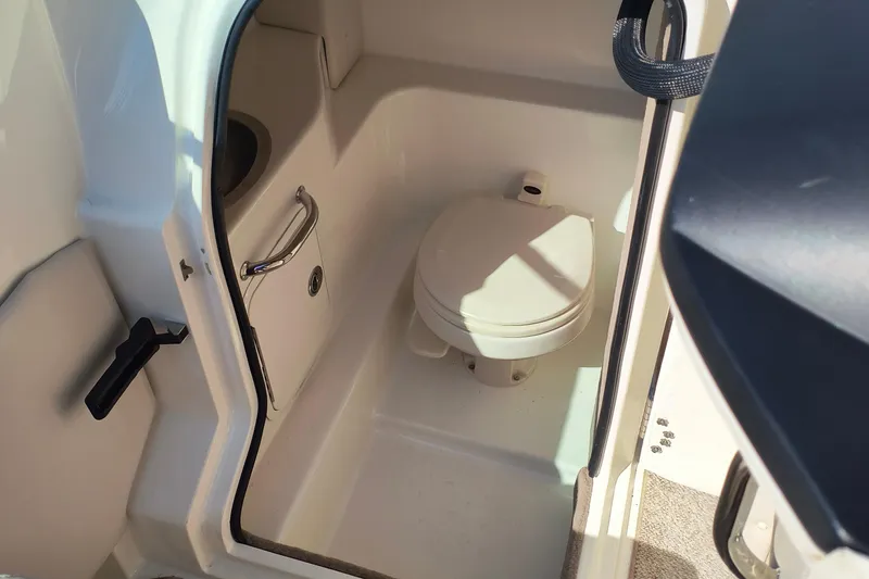 Slide: The Image of Interior of a 2005 Sea Ray 270 SLX boat showing a compact marine toilet. - 8
