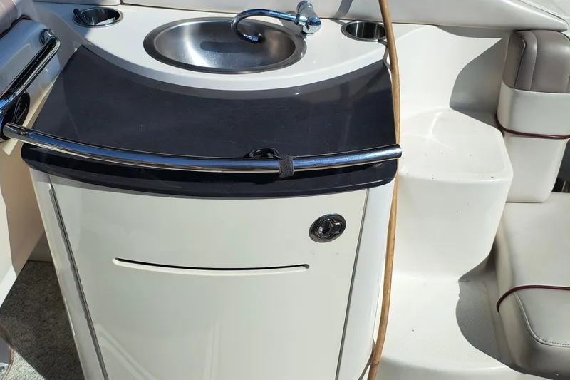 Slide: The Image of 2005 Sea Ray 270 SLX boat interior with sink and seating area. - 9