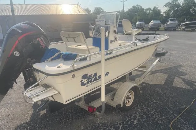 Slide: The Image of 2005 Carolina Skiff Sea Chaser 1800 boat on trailer, parked outdoors in sunlight. - 10