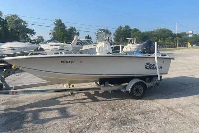 Slide: The Image of 2005 Carolina Skiff Sea Chaser 1800 boat on trailer in parking lot. - 3