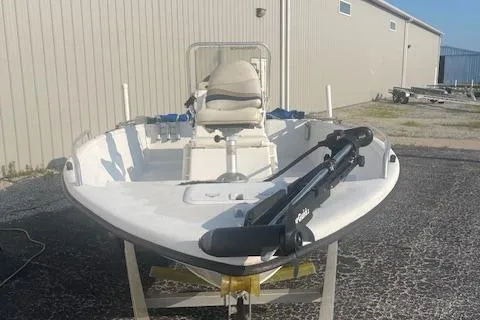 Slide: The Image of 2005 Carolina Skiff Sea Chaser 1800 boat on trailer, parked near a building. - 6