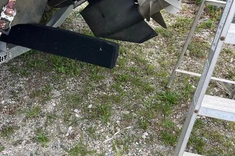 Slide: The Image of 2023 Chaparral 247 SSX boat propeller and ladder on gravel surface. - 11