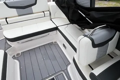 Slide: The Image of 2023 Chaparral 247 SSX boat interior with sleek, modern seating and gray flooring. - 13