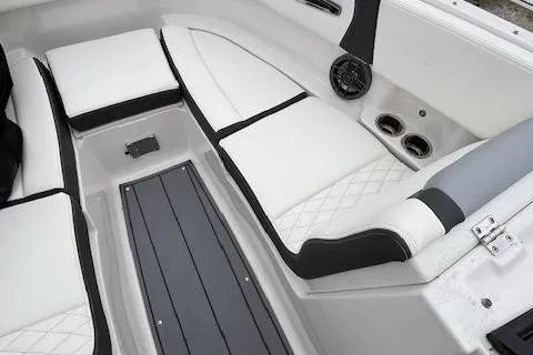 Slide: The Image of 2023 Chaparral 247 SSX boat interior with white seating and modern design. - 16