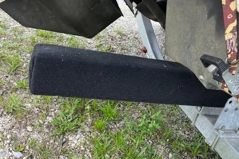 Slide: The Image of 2023 Chaparral 247 SSX boat trailer detail on gravel surface. - 6