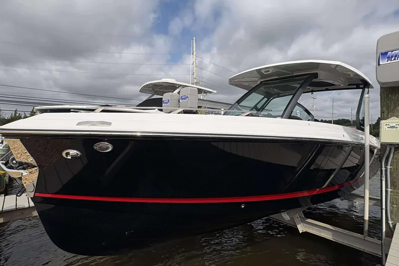 Slide: The Image of 2026 Monterey Elite 30 OB boat docked, featuring sleek design and modern amenities. - 1