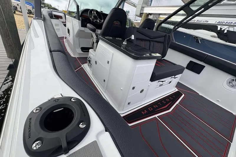 Slide: The Image of 2026 Monterey Elite 30 OB boat interior with sleek seating and modern design. - 10