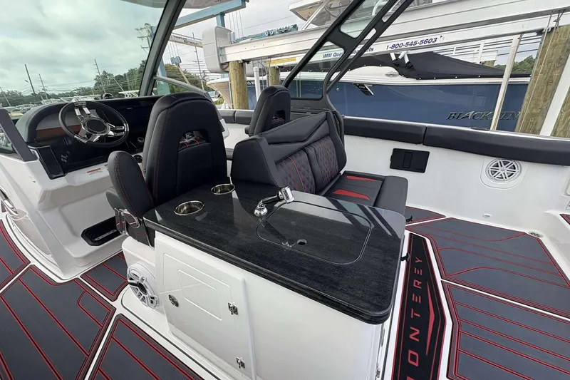 Slide: The Image of Interior of 2026 Monterey Elite 30 OB boat with sleek seating and modern dashboard. - 13