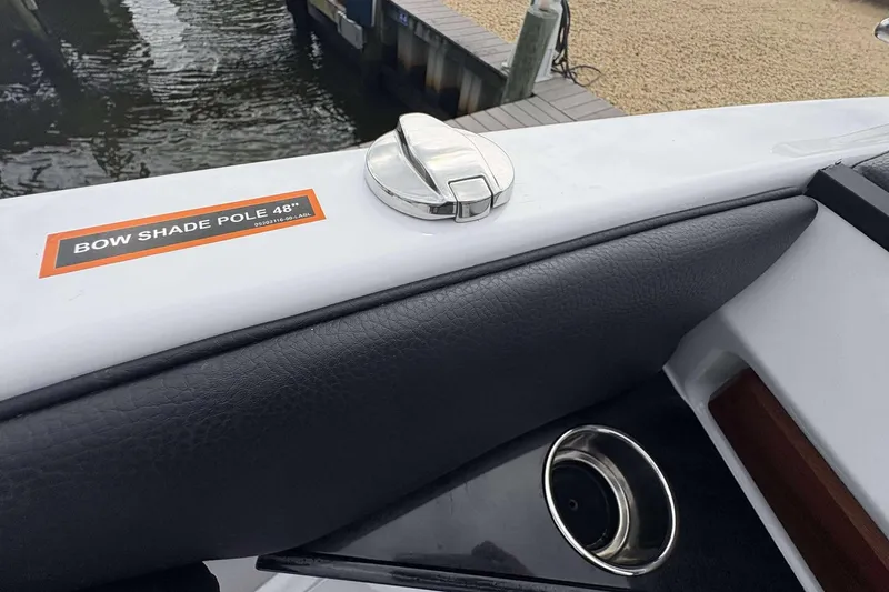 Slide: The Image of 2026 Monterey Elite 30 OB boat with bow shade pole and cup holder detail. - 19