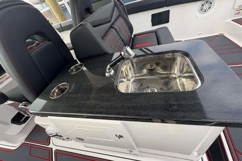 Slide: The Image of Luxury interior of 2026 Monterey Elite 30 OB boat with sleek sink and seating. - 21