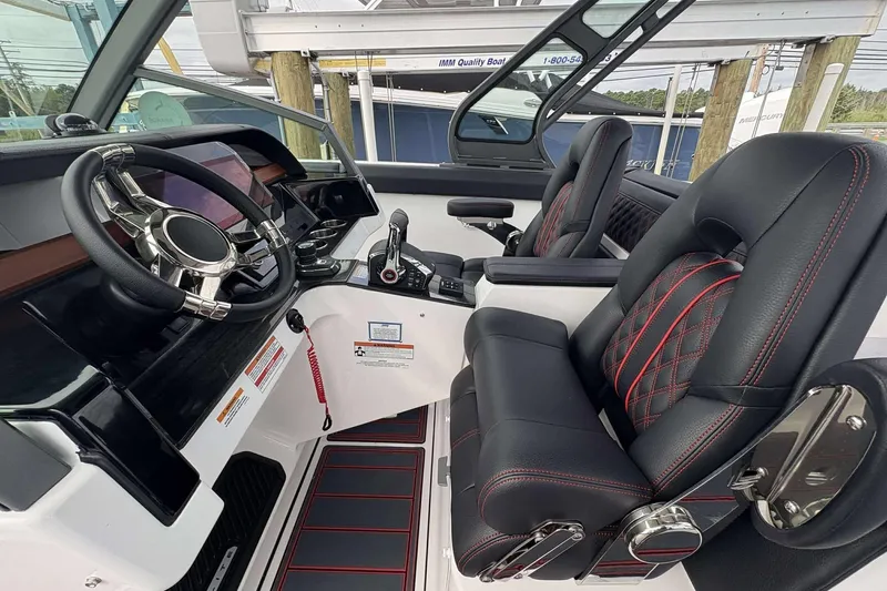 Slide: The Image of 2026 Monterey Elite 30 OB boat interior with luxury seating and modern steering console. - 26