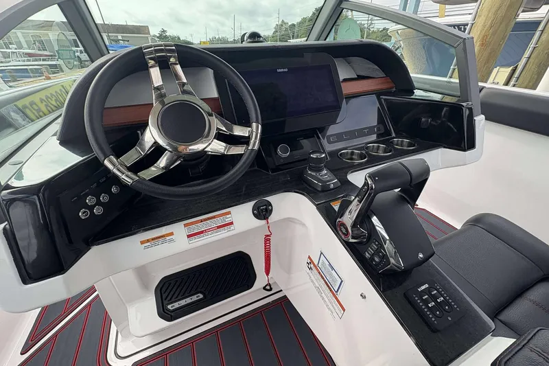 Slide: The Image of 2026 Monterey Elite 30 OB boat dashboard with modern steering and control panel. - 27