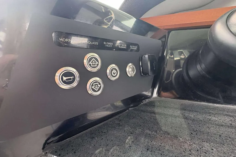 Slide: The Image of Control panel of 2026 Monterey Elite 30 OB boat with labeled buttons and switches. - 29