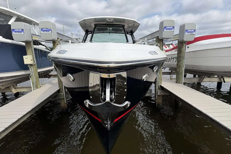 Slide: The Image of 2026 Monterey Elite 30 OB boat docked at marina, front view. - 3