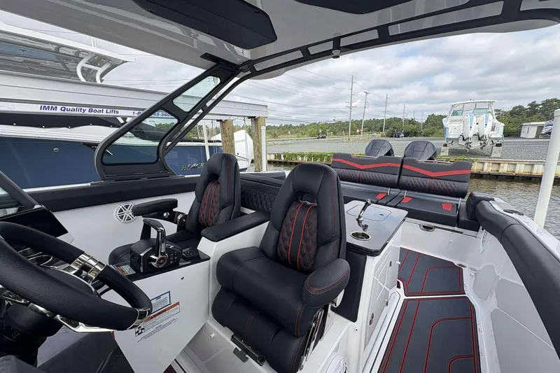 Slide: The Image of 2026 Monterey Elite 30 OB boat interior with luxurious seating and modern controls. - 30