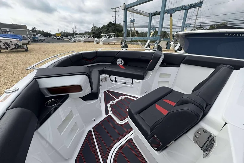Slide: The Image of 2026 Monterey Elite 30 OB boat interior with sleek black and red seating. - 31