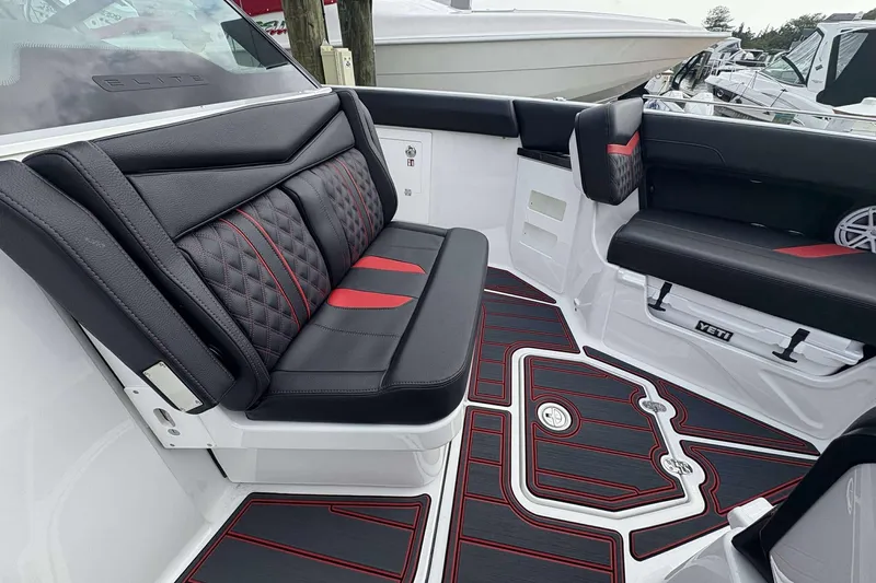 Slide: The Image of Luxurious interior of 2026 Monterey Elite 30 OB boat with stylish black and red seating. - 33