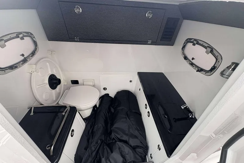 Slide: The Image of Interior of 2026 Monterey Elite 30 OB boat with toilet and compact sink area. - 34