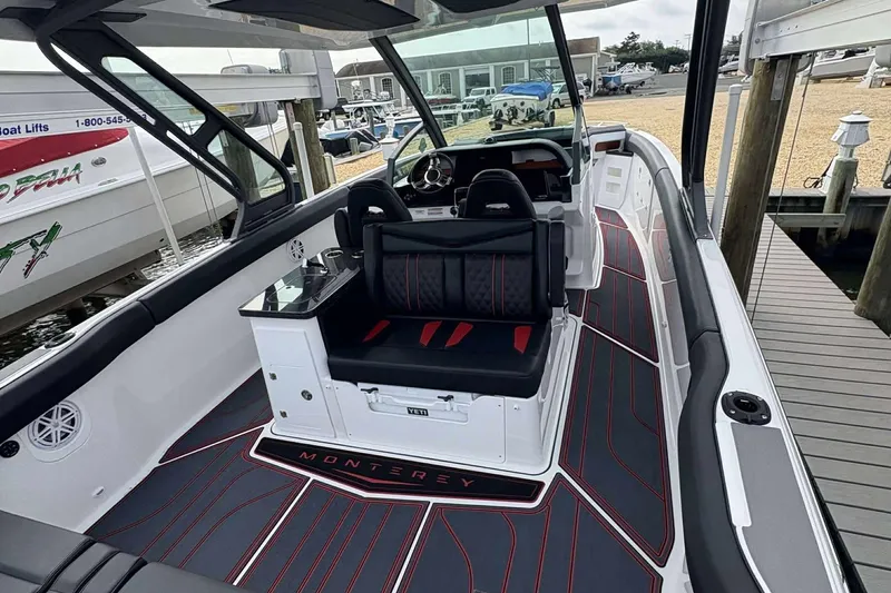 Slide: The Image of 2026 Monterey Elite 30 OB boat interior with sleek seating and modern design. - 37