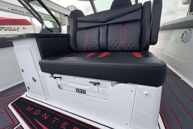 Slide: The Image of Luxurious seating on 2026 Monterey Elite 30 OB boat with Yeti cooler storage. - 38