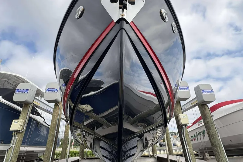 Slide: The Image of 2026 Monterey Elite 30 OB boat, sleek design, docked at marina under cloudy sky. - 4