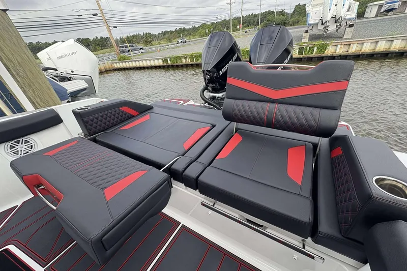 Slide: The Image of Luxury seating on 2026 Monterey Elite 30 OB boat with red and black upholstery. - 7