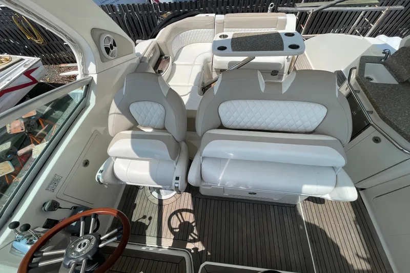 Slide: The Image of 2011 Chaparral 330 Signature boat interior with plush seating and steering wheel. - 10