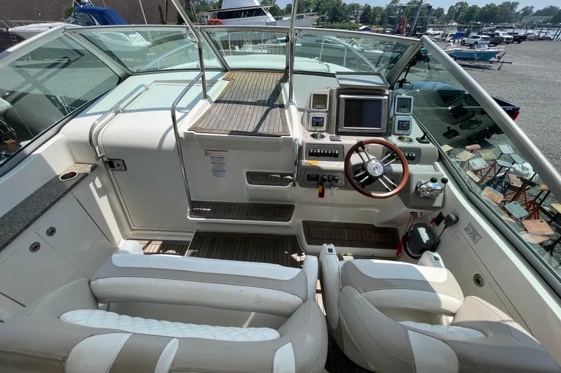 Slide: The Image of 2011 Chaparral 330 Signature boat cockpit with steering wheel and control panel. - 11