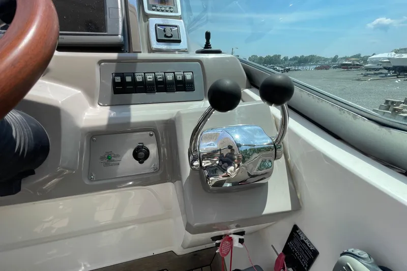 Slide: The Image of 2011 Chaparral 330 Signature boat controls and dashboard with dual throttle levers. - 15