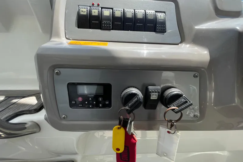 Slide: The Image of Control panel of a 2011 Chaparral 330 Signature boat with keys and switches. - 16
