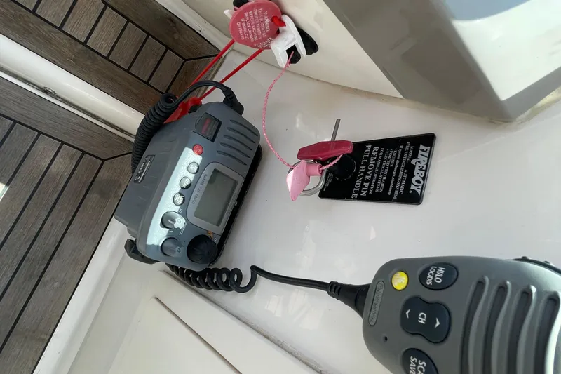 Slide: The Image of VHF radio and safety switch on 2011 Chaparral 330 Signature boat dashboard. - 17