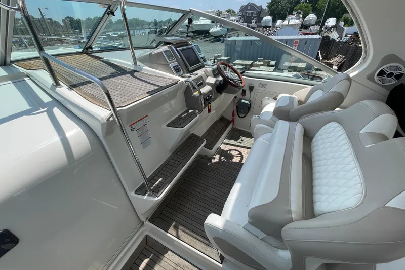 Slide: The Image of 2011 Chaparral 330 Signature boat cockpit with dual seats and modern dashboard. - 18