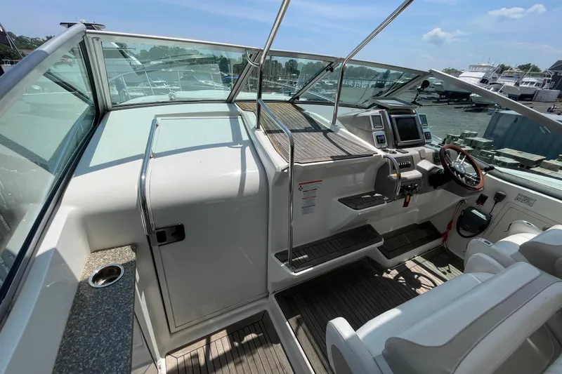 Slide: The Image of 2011 Chaparral 330 Signature boat cockpit with steering wheel and navigation controls. - 19