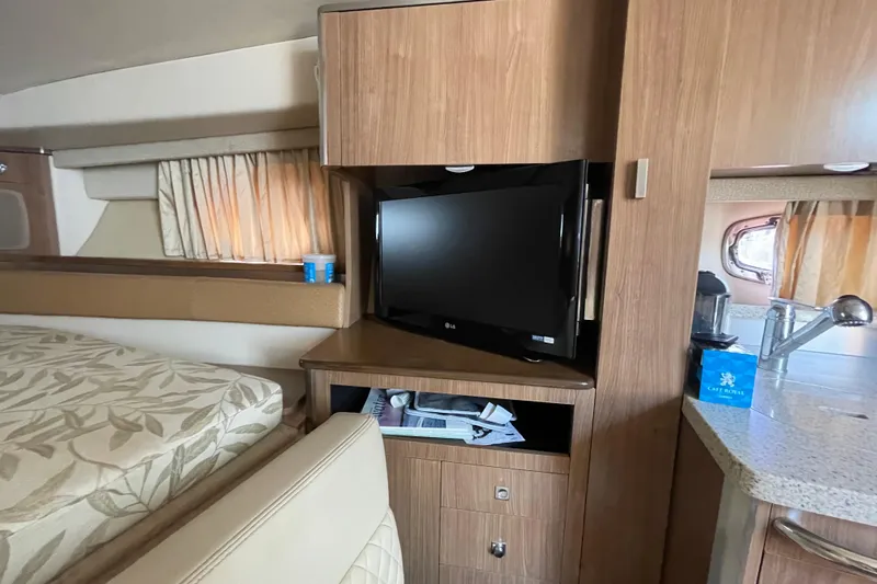 Slide: The Image of Interior of 2011 Chaparral 330 Signature yacht with TV, bed, and kitchenette. - 25