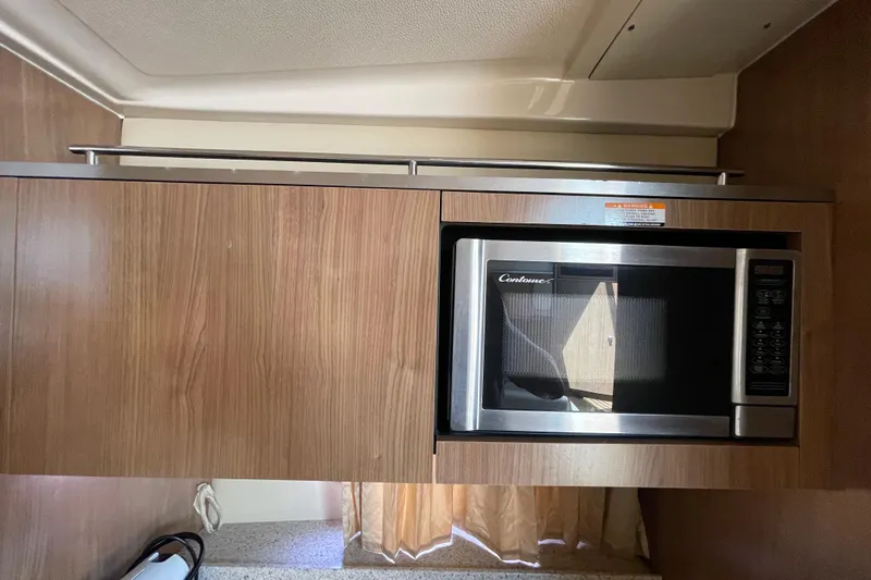 Slide: The Image of Microwave in 2011 Chaparral 330 Signature boat kitchen with wood cabinetry. - 27