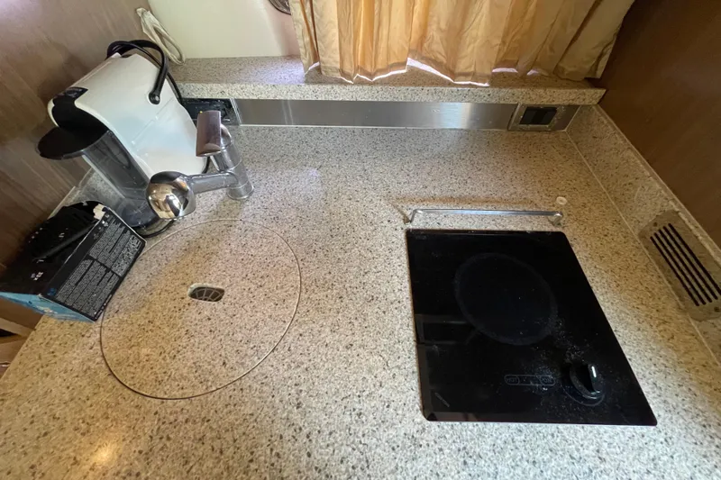 Slide: The Image of Chaparral 330 Signature 2011 kitchen with granite countertop, sink, and electric cooktop. - 28