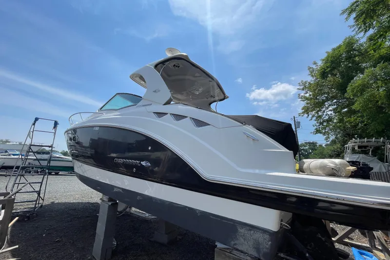 Slide: The Image of 2011 Chaparral 330 Signature boat on dry dock under clear blue sky. - 3