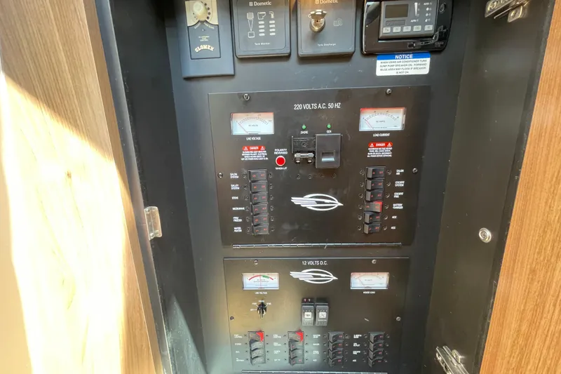 Slide: The Image of Electrical control panel of a 2011 Chaparral 330 Signature boat, featuring voltage meters. - 34