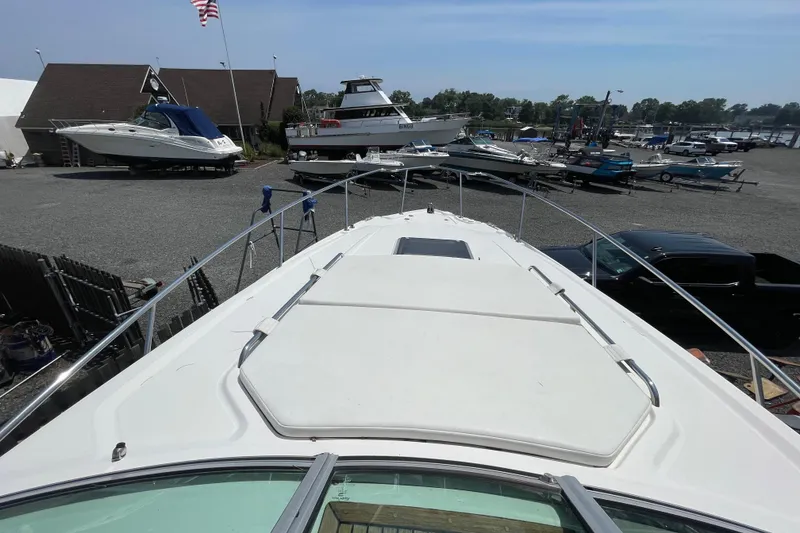 Slide: The Image of 2011 Chaparral 330 Signature boat on display at a marina with other vessels. - 35