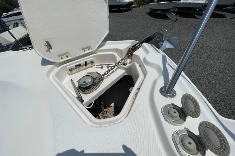 Slide: The Image of Open anchor compartment on 2011 Chaparral 330 Signature boat, showcasing chain and winch. - 36