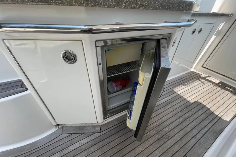 Slide: The Image of Open mini fridge on 2011 Chaparral 330 Signature boat, showing interior contents. - 39